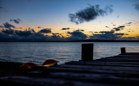A scenic view of a blue ocean on a sunset sky backgroundの写真素材
