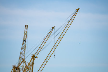 A low angle shot of a crane under a clear sky on a gloomy dayの写真素材