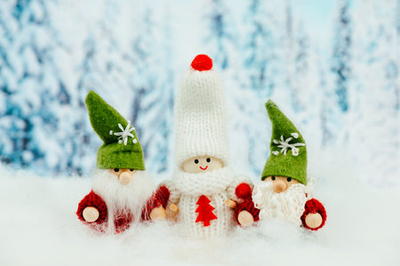 Little cute girls and christmas elves standing in the snow, festive greeting card, copy space, wintertimeの写真素材