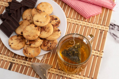A closeup of a glass of hot tea with a teabag on the counterの写真素材