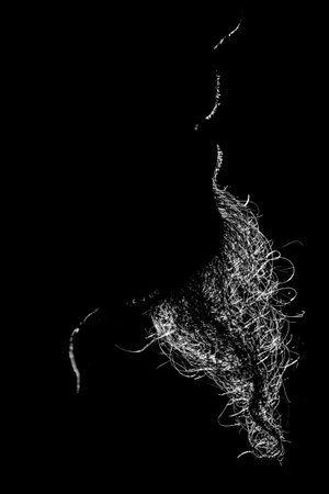 The silhouette of a person in the backlight with a goatee beard