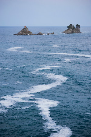 A beautiful morning view on Adriatic sea and rocks in Petrovac, Montenegro with a cloudy skyの写真素材