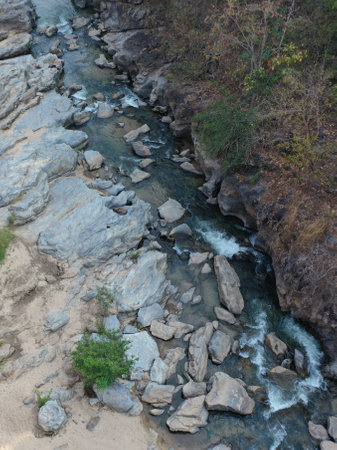 A beautiful view of a river with rocks and large stones