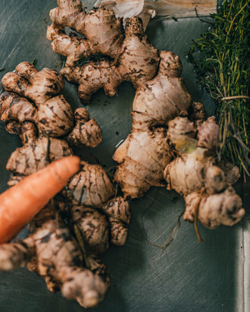 A top view of ginger on a wooden board in the kitchen