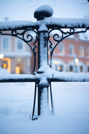 A vertical shot of a snowy fence in winterの写真素材