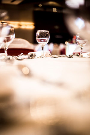 A vertical shot of a glass cup full of liquid on a table