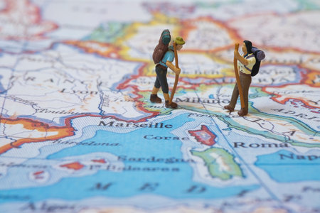 A closeup shot of miniature hikers on a map