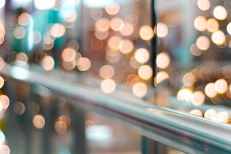 A closeup of railing with bokeh lights in the background