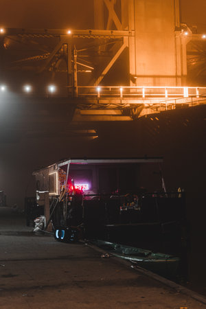 A vertical shot of the ship moored in the harbor at night.