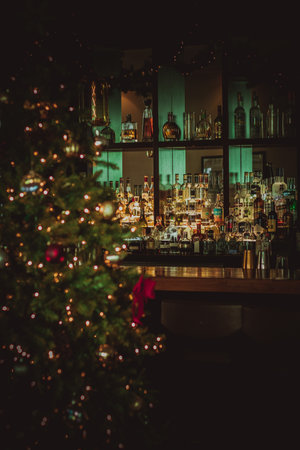 A vertical shot of a Christmas tree in the bar