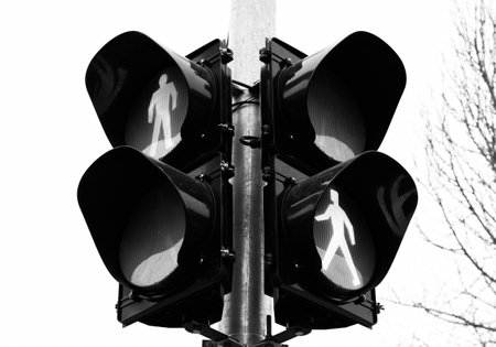 A greyscale shot of a traffic ight for the pedestrians