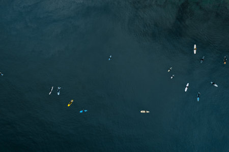 A top view of surfers in blue ocean water