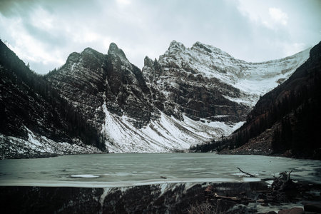 A beautiful view of a lake surrounded by snow-capped mountains in Canada