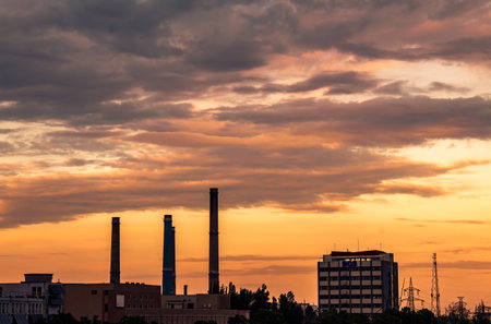 A scenic view of urban buildings on a bright sunset sky backgroundの写真素材