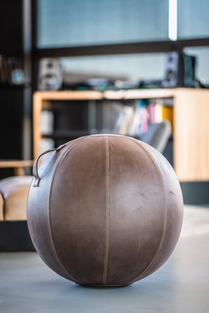 A vertical closeup shot of a leather ball in an officeの写真素材