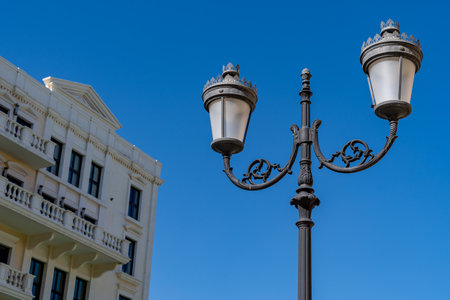 A view of a street lamp with a building in the background in Pearl-Qatar in Doha, Qatarの写真素材