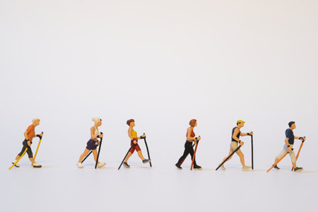 A group of miniature joggers in a row while running on white background