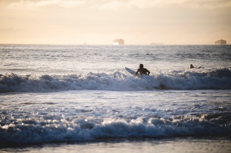 A landscape view of sea waves and a man surfing. Newport Beach, Californiaの写真素材