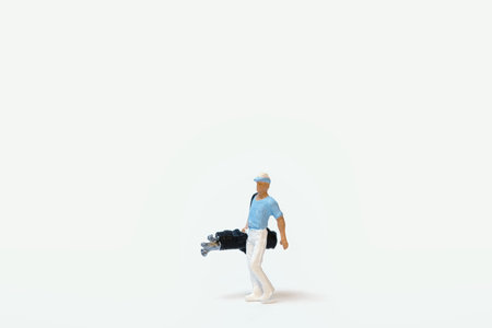 A miniature golfer with golf club bag on a white background, copy space