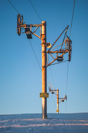 A Standard Wooden Telegraph Pole against A blue sky in Low Tatras on  snow land in Slovakiaの写真素材