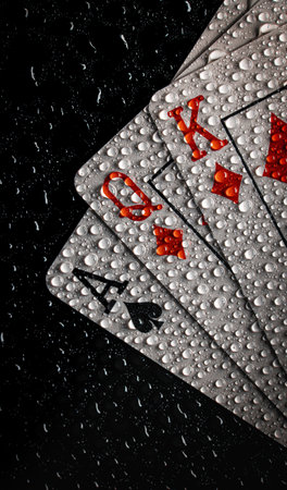 A vertical closeup of the wet cards on black background.