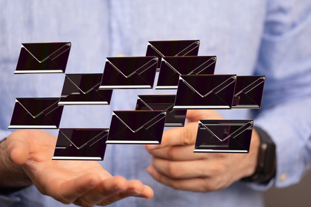 A closeup shot of hands showing digital, black message iconsの写真素材