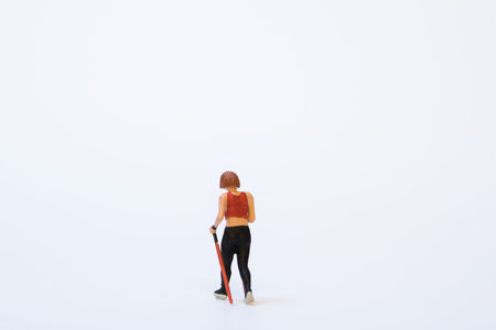 A miniature nordic walker during training - white background, copy spaceの写真素材