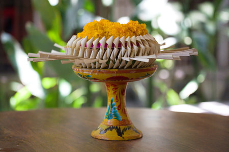 A closeup shot of a colorful decorative vase on a wooden table with blurred backgroundの写真素材