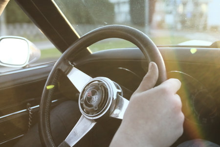 A person holding the wheel of a retro carの写真素材