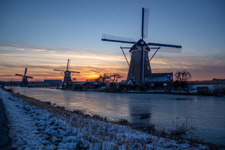 A beautiful shot of the Kinderdijk Windmills at sunset in the Netherlands