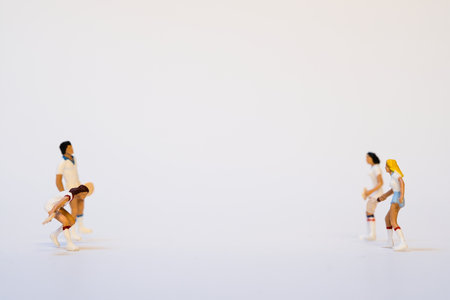 Two pairs of miniature tennis athletes with tennis rackets in action positionの写真素材