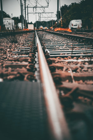 A vertical shot of a long train railroad in a rural area