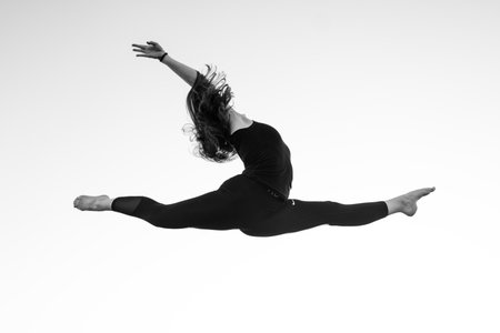 A grayscale of a ballerine in the airの写真素材