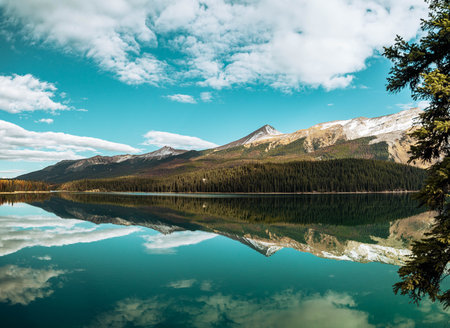 A beautiful view of a lake surrounded by snow-capped mountains in Canada