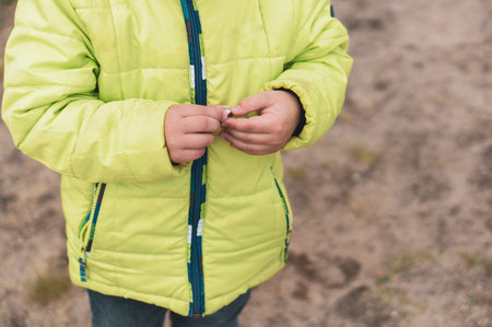 A closeup of young boy hands standing in a parkの写真素材