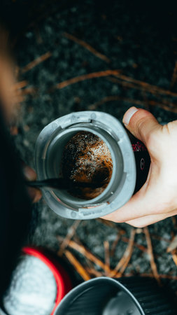 A closeup shot of a cup of coffee on hand in the forestの写真素材
