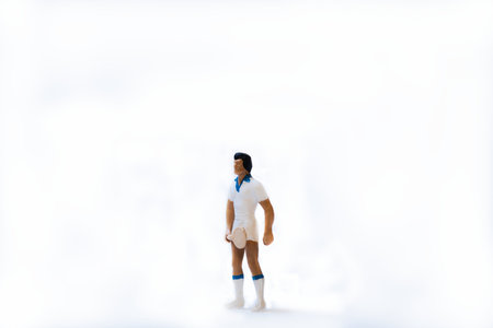 A miniature tennis athlete with a tennis racket on a white backgroundの写真素材