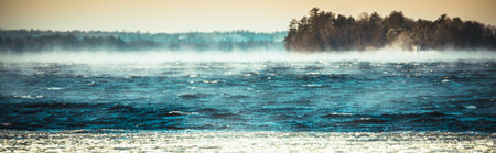 A panoramic shot of steam rising from the riverの写真素材