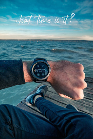 A vertical shot of a person checking the time on his watch