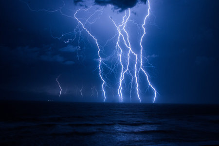 A flash of lightning over the sea thunderstorm clouds