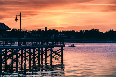 A mesmerizing shot of a seascape during the sunset under the pink and purple skiesの写真素材