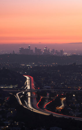 A vertical shot of a cityscape on a bright sunset sky backgroundの写真素材