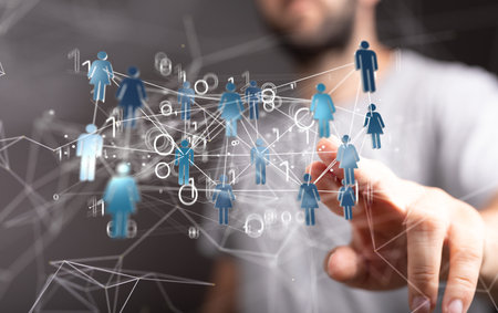 A male's hand holding an illustration of a group of people - network concept