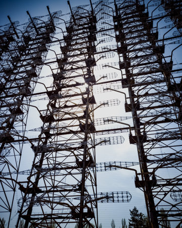 A vertical low angle shot of tall industrial telephone towers