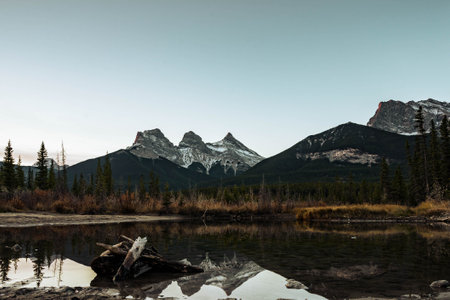 A beautiful view of a lake surrounded by snow-capped mountains in Canada