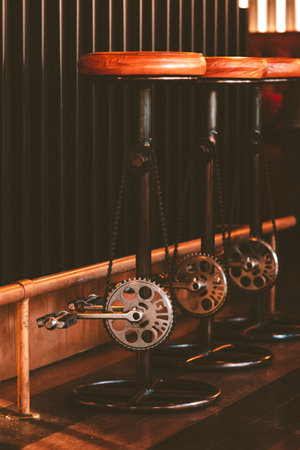 A closeup of three Pedal Stools with orange chairs on a wooden shelfの写真素材