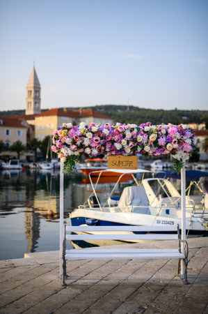 A bench covered in flowers located in Supetar on the island of Brac, Croatiaの写真素材