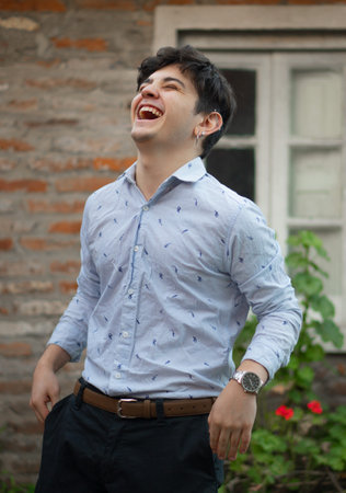 A vertical shot of an Argentinian male posing in a shirt outdoorsの写真素材