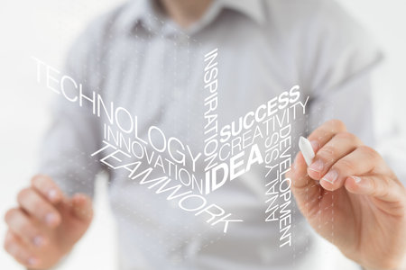 A businessman pointing at concept ideas with a penの写真素材