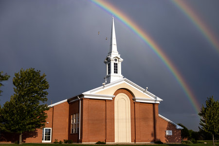 A scenic view of rainbows over the Church of Jesus Christ of Latter-day Saints in Montreal, Canadaの写真素材